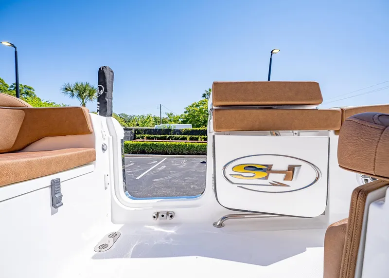 Slide: The Image of 2025 Sea Hunt Ultra 265 SE boat interior with brown seating and logo. - 8