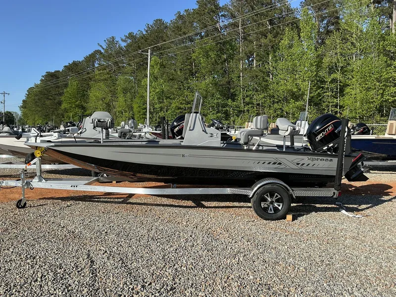 Slide: The Image of 2025 Xpress Hyper-Lift Series H20B boat with new console on a trailer, parked outdoors. - 1