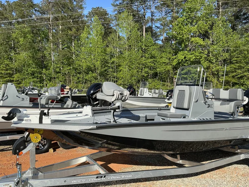 Slide: The Image of 2025 Xpress Hyper-Lift Series H20B boat with new console, parked on a trailer. - 2