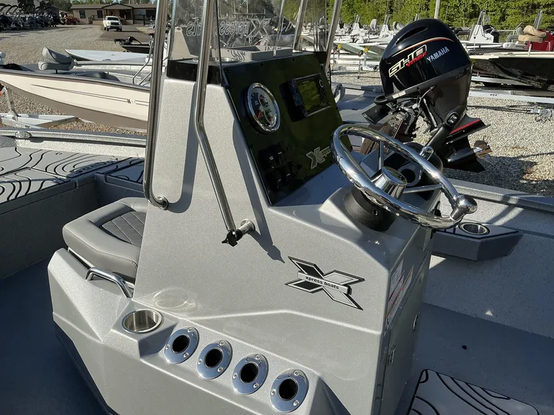 Slide: The Image of 2025 Xpress Hyper-Lift Series H20B boat console with steering wheel and Yamaha engine. - 6