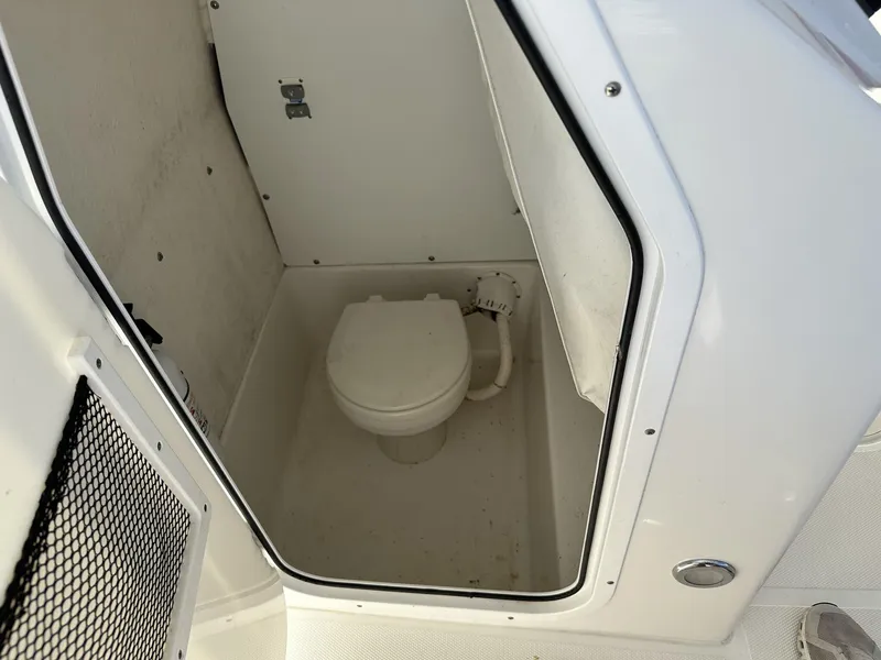 Slide: The Image of 2017 Sea Hunt Edge 24 boat interior with compact marine toilet. - 12