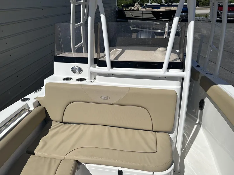 Slide: The Image of 2017 Sea Hunt Edge 24 boat interior with beige seating and cup holders. - 13