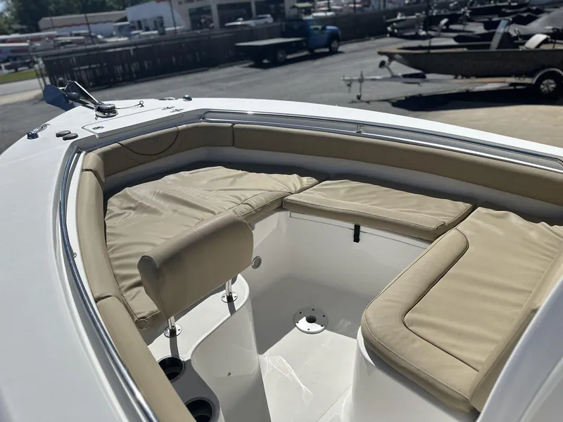 Slide: The Image of 2017 Sea Hunt Edge 24 boat with beige cushioned seating in the bow area. - 14