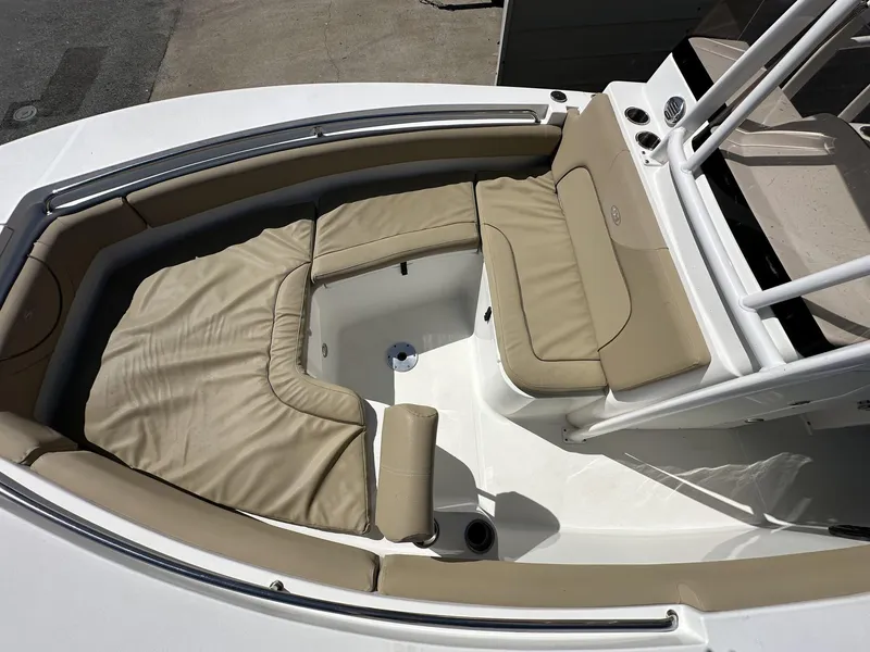 Slide: The Image of 2017 Sea Hunt Edge 24 boat interior with beige cushioned seating and storage area. - 7