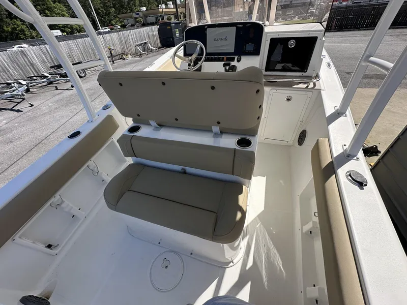 Slide: The Image of 2017 Sea Hunt Edge 24 boat interior with beige seating and Garmin navigation system. - 9
