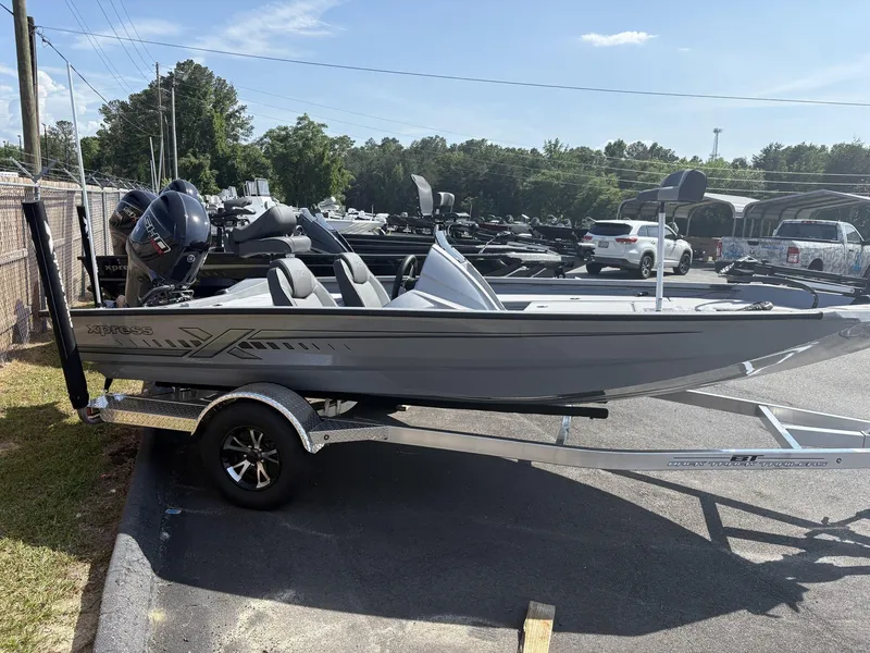 Slide: The Image of 2025 Xpress Hyper-Lift Bass Series boat on trailer, parked outdoors. - 1
