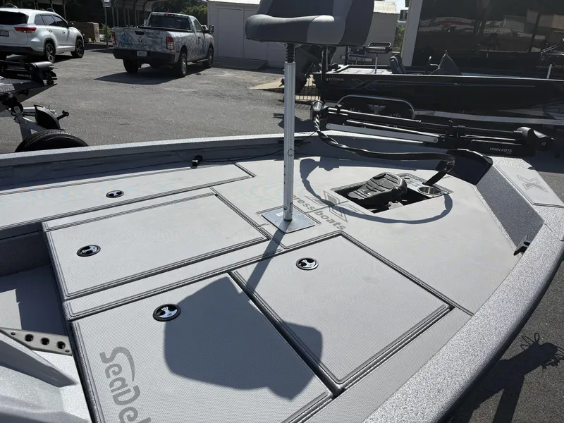 Slide: The Image of 2025 Xpress Hyper-Lift Bass Series boat deck with seating and storage compartments. - 2