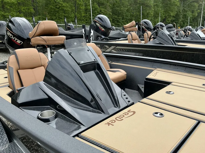 Slide: The Image of 2025 Xpress Hyper-Lift Bass Series boat with tan seats and sleek black design. - 3