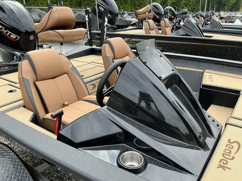 Slide: The Image of 2025 Xpress Hyper-Lift Bass Series boat with tan seats and sleek black console. - 8