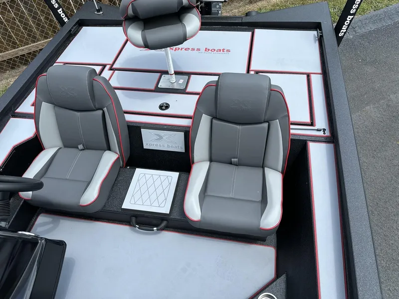 Slide: The Image of 2025 Xpress Hyper-Lift Bass Series boat interior with gray and red seating. - 8