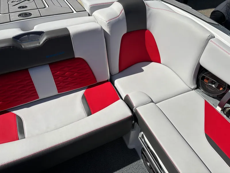Slide: The Image of 2020 MasterCraft X24 boat interior with red and white seating, featuring premium upholstery. - 10