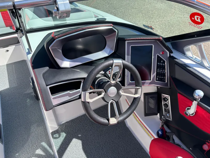 Slide: The Image of 2020 MasterCraft X24 boat dashboard with steering wheel and control panel. - 14