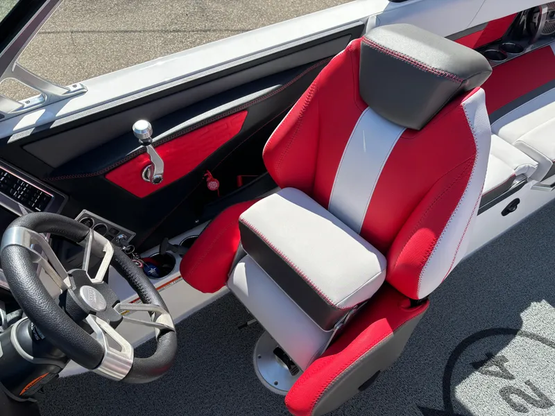 Slide: The Image of 2020 MasterCraft X24 boat interior with red and white captain's seat and steering wheel. - 16