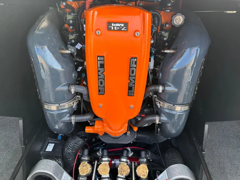 Slide: The Image of 2020 MasterCraft X24 Ilmor engine, vibrant orange cover, detailed view. - 17