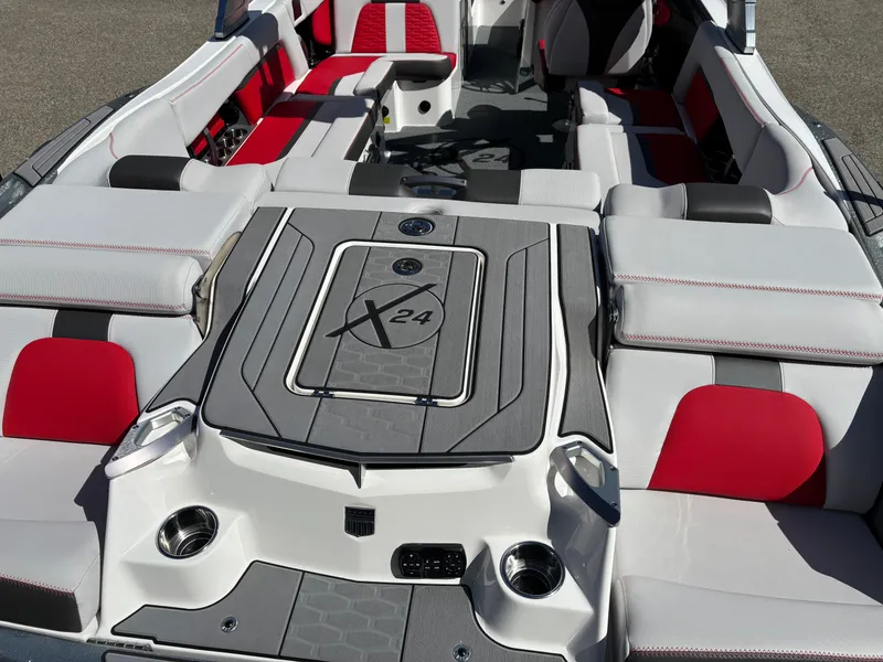 Slide: The Image of 2020 MasterCraft X24 boat interior with red and gray seating, showcasing luxury design. - 5