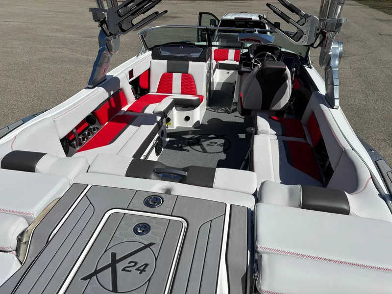 Slide: The Image of 2020 MasterCraft X24 boat interior with red and white seating, sleek design. - 6