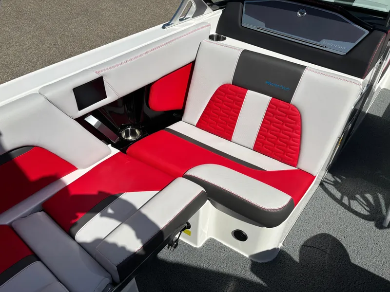 Slide: The Image of 2020 MasterCraft X24 interior with red and white seating, featuring modern design and cup holders. - 8