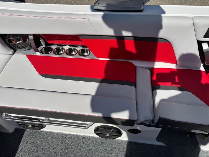 Slide: The Image of 2020 MasterCraft X24 boat interior with red and gray seating, cup holders, and speakers. - 9