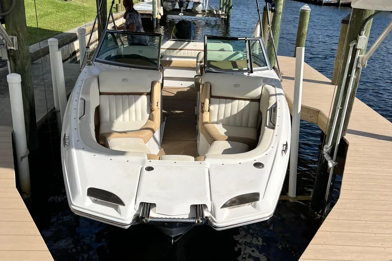 The Image of 2020 Cobalt 25SC boat docked, featuring spacious seating and sleek design. - 0