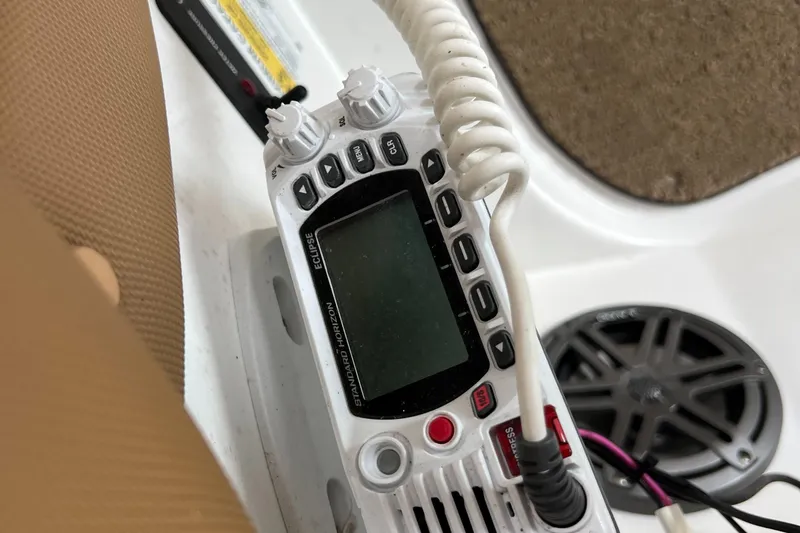 Slide: The Image of VHF marine radio on a 2020 Cobalt 25SC boat dashboard. - 12