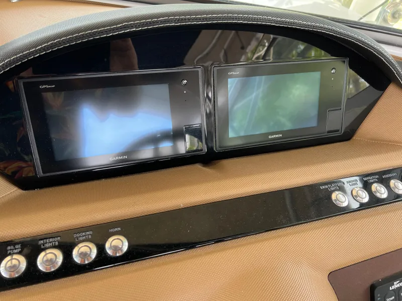 Slide: The Image of Dashboard of 2020 Cobalt 25SC boat with Garmin displays and control buttons. - 14