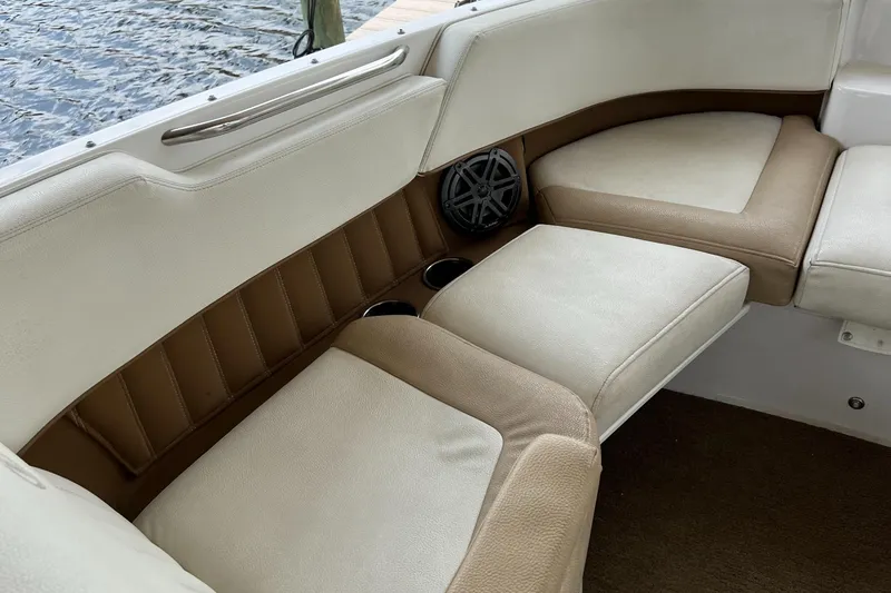 Slide: The Image of 2020 Cobalt 25SC boat interior with beige seating and speaker. - 16