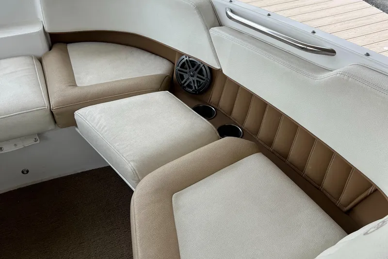 Slide: The Image of 2020 Cobalt 25SC boat interior with beige seating and cup holders. - 20