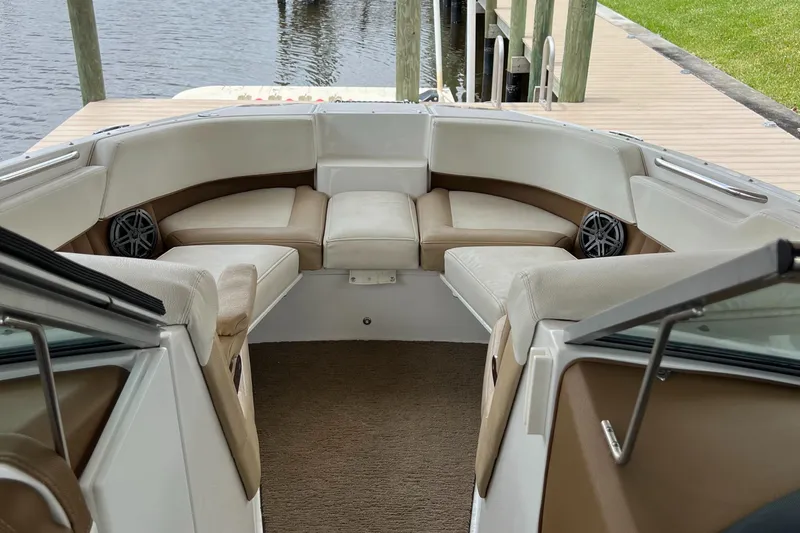 Slide: The Image of 2020 Cobalt 25SC boat interior with beige seating and waterfront view. - 22