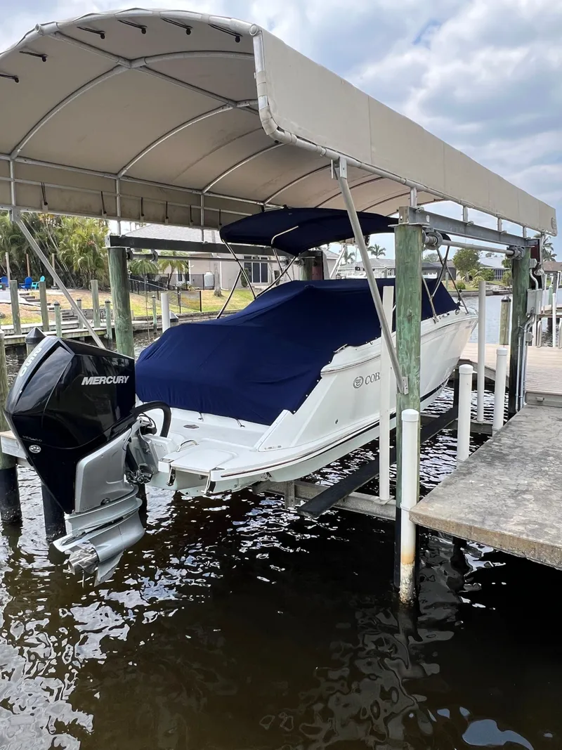 Slide: The Image of 2020 Cobalt 25SC boat with Mercury engine on covered dock. - 9