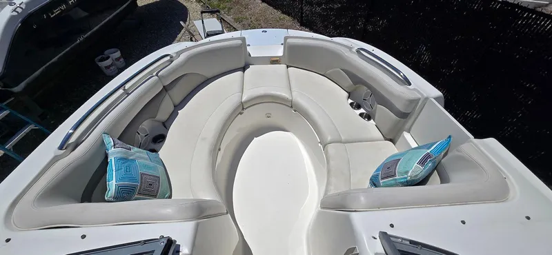 Slide: The Image of 2006 Chaparral Sunesta 254 boat interior with cushioned seating and decorative pillows. - 10