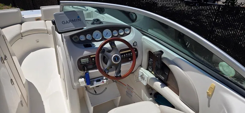 Slide: The Image of 2006 Chaparral Sunesta 254 boat cockpit with Garmin navigation system and wood-accented steering wheel. - 11