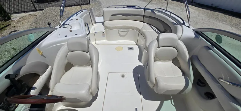 Slide: The Image of 2006 Chaparral Sunesta 254 boat interior with white seating and spacious layout. - 13