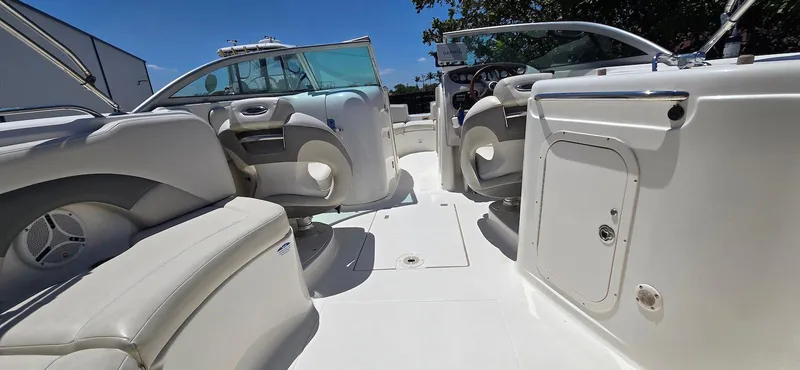 Slide: The Image of 2006 Chaparral Sunesta 254 boat interior with white seating and open deck. - 15