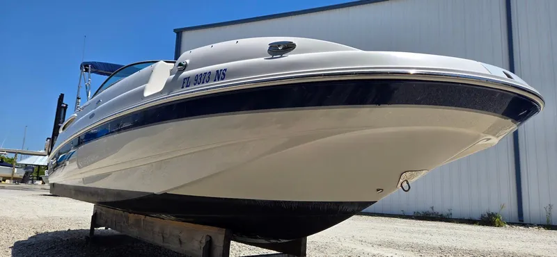 Slide: The Image of 2006 Chaparral Sunesta 254 boat on a trailer, viewed from the front, under clear blue sky. - 22