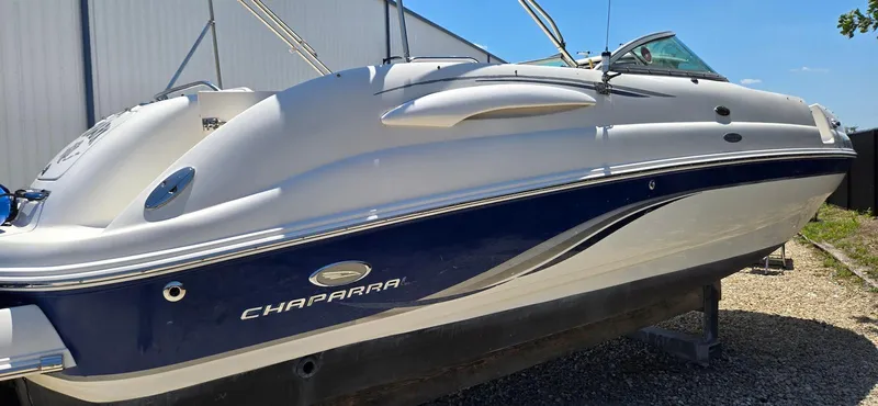 Slide: The Image of 2006 Chaparral Sunesta 254 boat with sleek design, docked outdoors. - 23