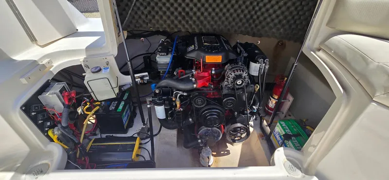 Slide: The Image of Engine compartment of a 2006 Chaparral Sunesta 254 boat, showcasing mechanical components. - 26