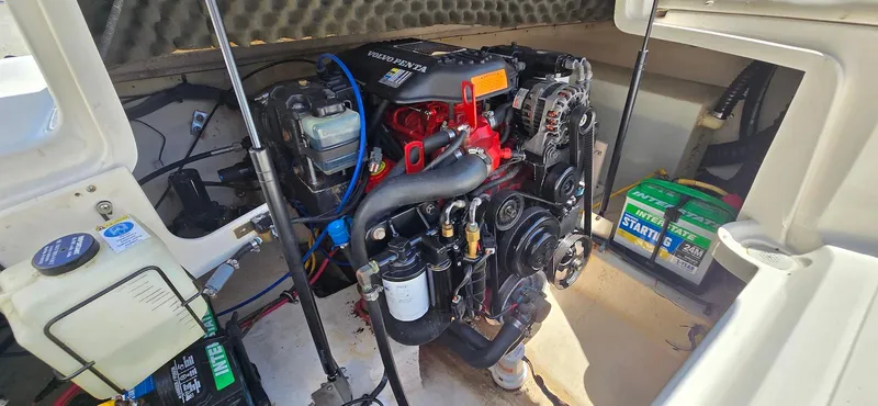 Slide: The Image of Engine compartment of a 2006 Chaparral Sunesta 254 boat, showcasing detailed mechanical components. - 27