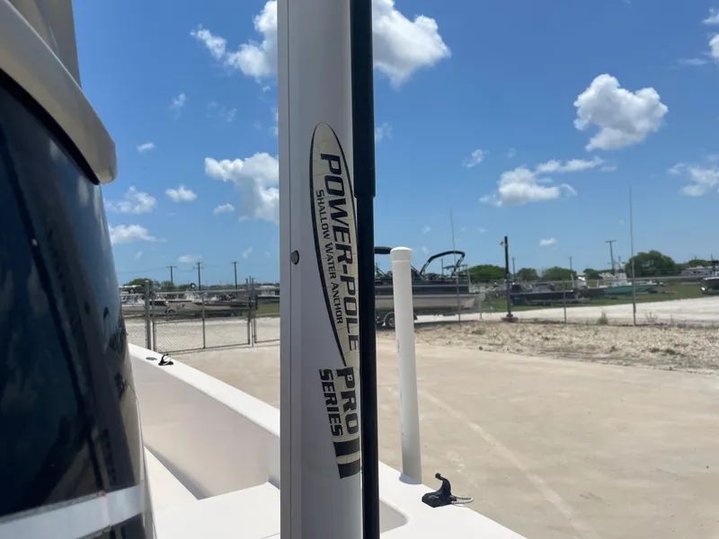 Slide: The Image of 2002 Pathfinder 2200v with Power-Pole Pro Series II anchor under a clear blue sky. - 12