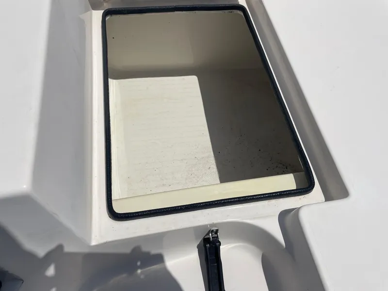 Slide: The Image of Open storage compartment on a 2002 Pathfinder 2200v boat, showing interior details. - 18