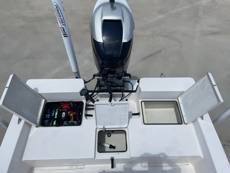 Slide: The Image of 2002 Pathfinder 2200v boat with open storage compartments and outboard motor. - 21