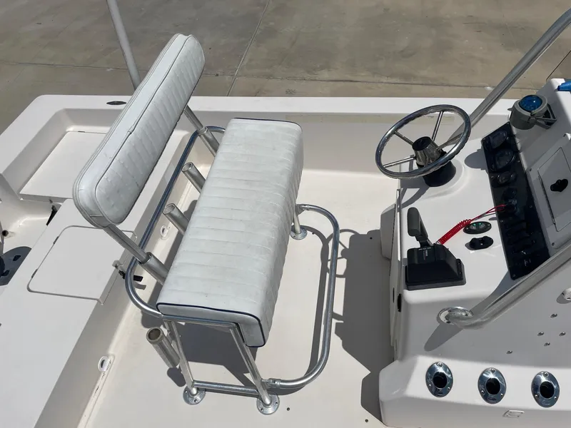 Slide: The Image of 2002 Pathfinder 2200v boat interior with steering console and seating. - 23