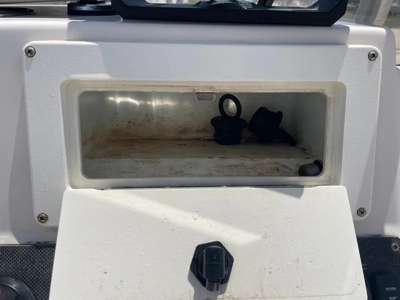 Slide: The Image of Open storage compartment on a 2002 Pathfinder 2200v boat dashboard. - 27