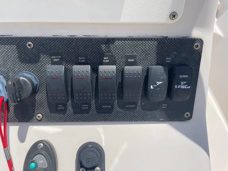 Slide: The Image of Control panel of a 2002 Pathfinder 2200v boat with various switches and trim tab controls. - 29