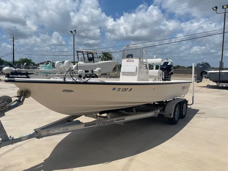 Slide: The Image of 2002 Pathfinder 2200v boat on trailer under cloudy sky, featuring MotorGuide equipment. - 3