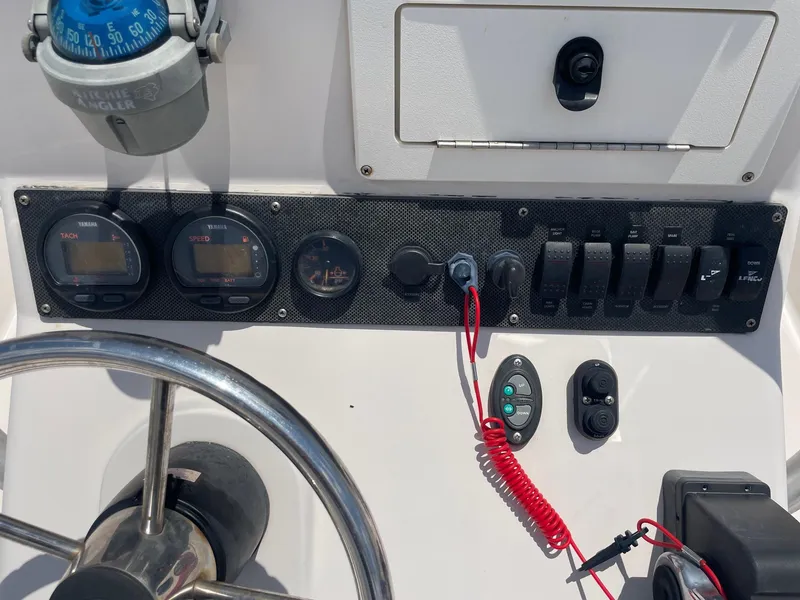 Slide: The Image of Control panel of a 2002 Pathfinder 2200v boat with gauges and switches. - 30