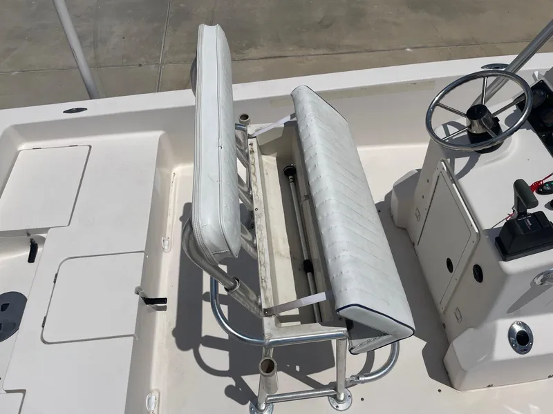 Slide: The Image of 2002 Pathfinder 2200v boat interior with white seating and steering console. - 31