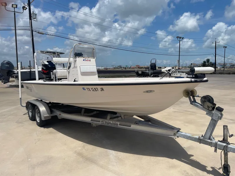 Slide: The Image of 2002 Pathfinder 2200v boat on trailer under a clear blue sky. - 8