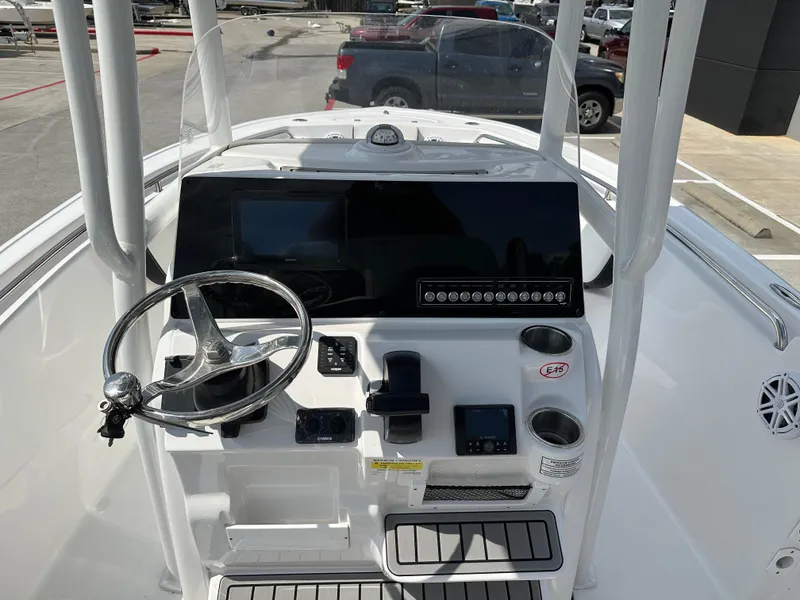 Slide: The Image of 2025 Tidewater 210CC boat dashboard with steering wheel and control panel. - 11
