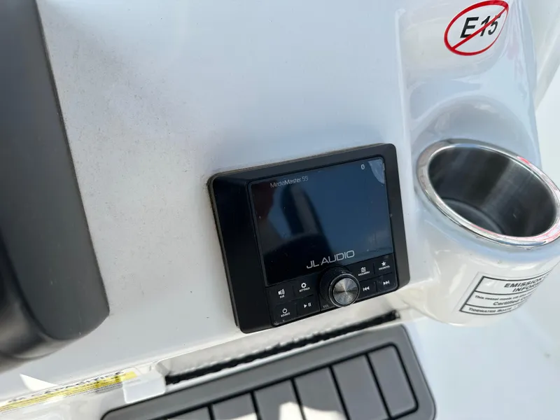 Slide: The Image of JL Audio system on 2025 Tidewater 210CC boat dashboard with cup holder. - 14