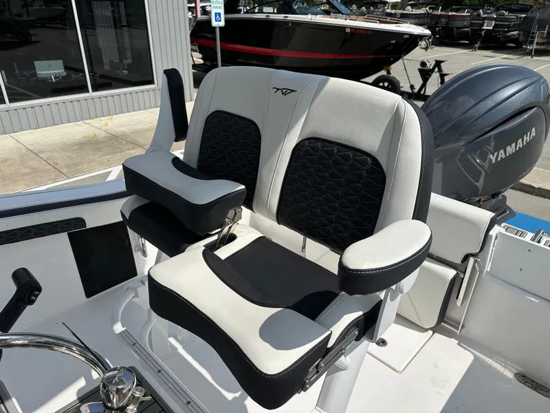 Slide: The Image of 2025 Tidewater 210CC boat seat with Yamaha engine in a showroom setting. - 15